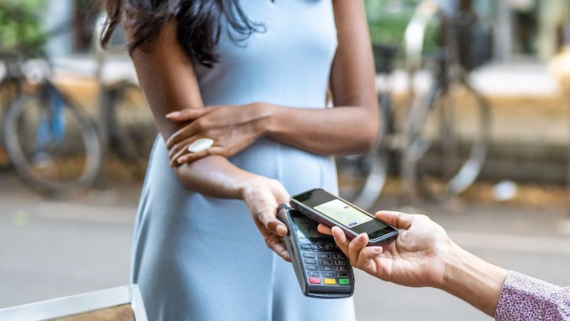 woman taking contactless payment