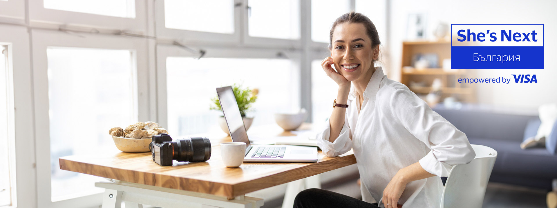 woman at desk and visa shes next logo