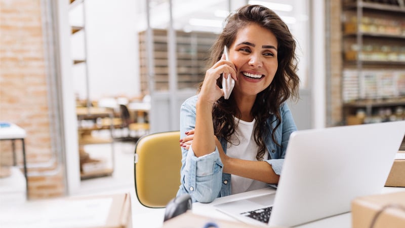 woman on phone at desk